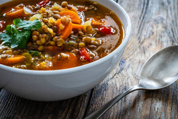 istock Fresh vegetable soup with lentil on wooden table 2086262557