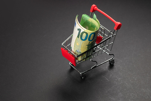 100 euro banknote in mini shopping trolley. Shopping cart concept or rich business
