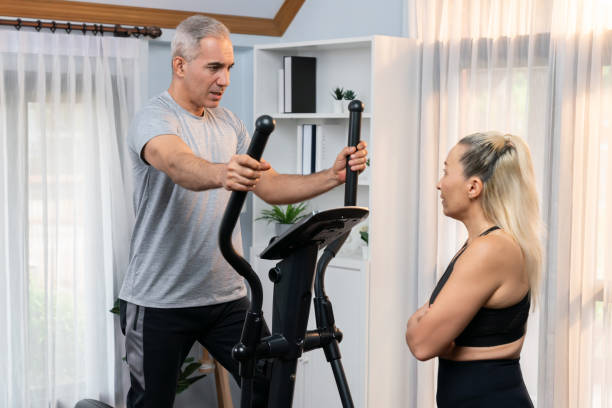 istock Active senior couple running on elliptical running machine. Clout 2086277413