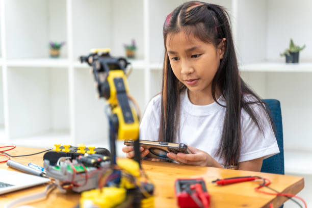 istock Happy young girl enjoy working on her robot kit at home 2086282012