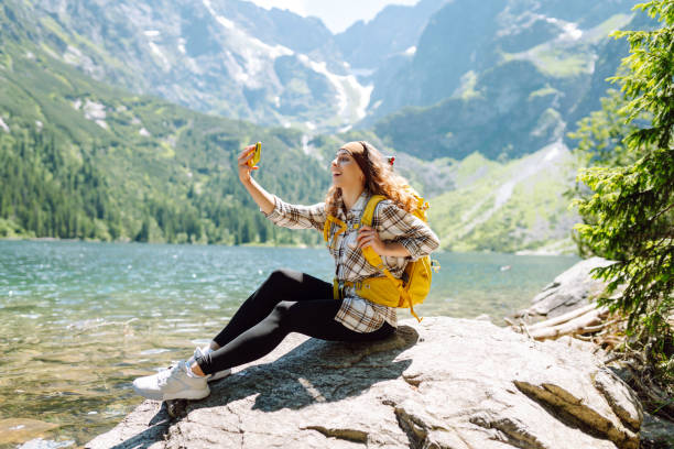 istock Happy tourist walking and takes selfie using smartphone camera. 2086294144