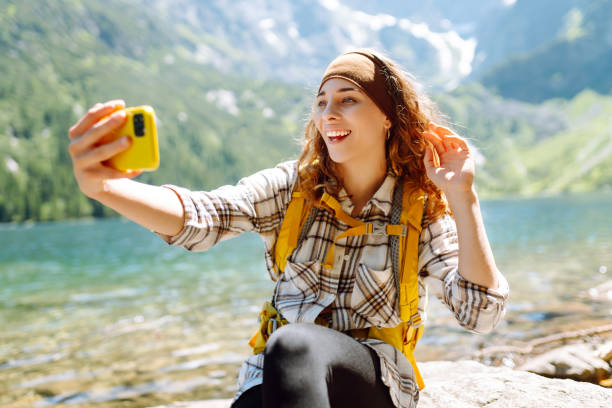 istock Happy tourist walking and takes selfie using smartphone camera. 2086294658