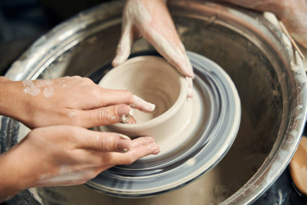 istock Female ceramic artist working with pottery wheel making handcrafted plate 2086309046