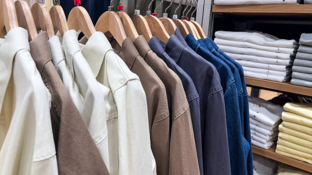 istock Various color shirts at shelf in shop. 2086324508