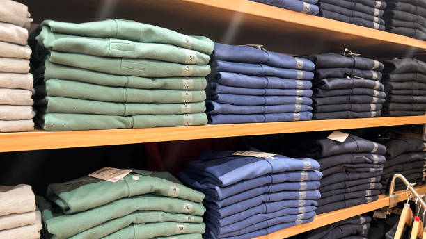 istock Various color shirts at shelf in shop. 2086326109