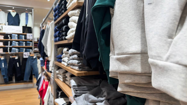 istock Various color shirts at shelf in shop. 2086326112