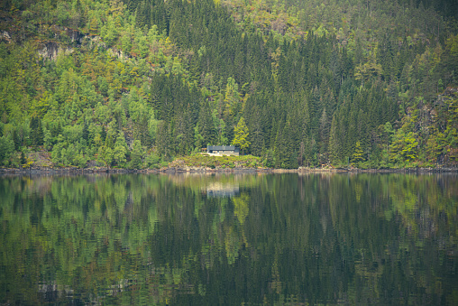 reflection of a house in the lake in the mountains