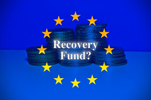 Doubts and uncertainties about the European Recovery and Resilience Plan against the crisis of the Covid virus pandemic - Coins with european flag and question mark