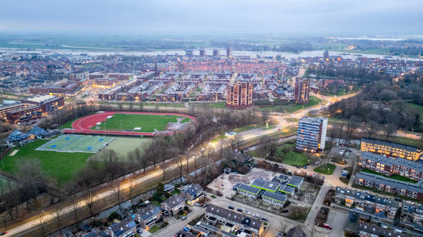 Kampen, Overijssel, The Netherlands - January 6th, 2024: Aerial view on Kampen in The Netherlands. Evening view with the football/ soccer fields