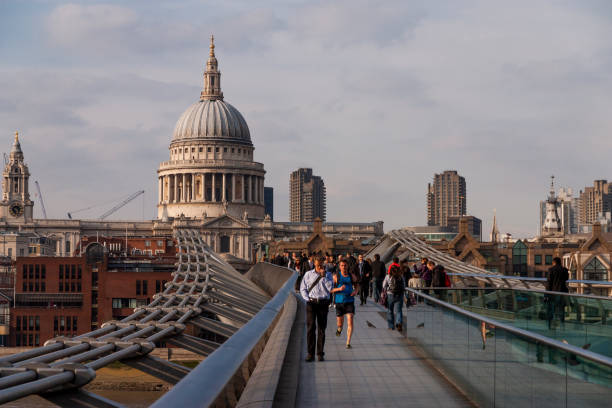 Wide angle color image depicting the international landmark of the Millennium Bridge in London, UK, looking across to the famous dome of St Paul's cathedral. The bridge is abandoned with no people during the global lockdown caused by the coronavirus (Covid-19) pandemic.
