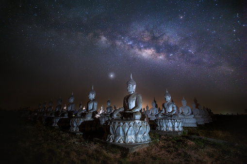 Milky Way and Buddha statue at Sa Kaeo Province, Thailand.