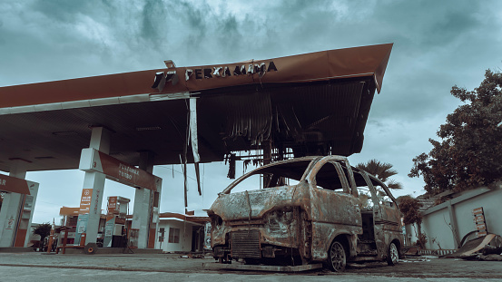 Kediri, East Java, Indonesia - March 14, 2024 : Burnt out car in the gas station