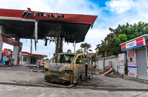 Kediri, East Java, Indonesia - March 14, 2024 : Burnt out car in the gas station