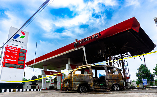 Kediri, East Java, Indonesia - March 14, 2024 : Burnt out car in the gas station