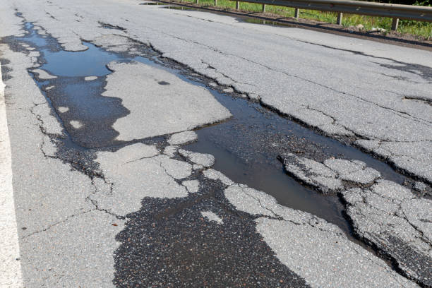 istock Potholes on bad asphalt road. Closeup 2086377481