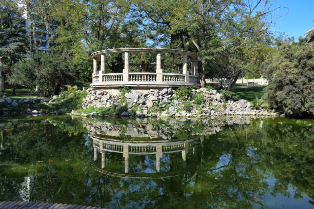 Stone gazebo with beautiful reflection on the water in the Latvian Kemeri National Park in November 2021.