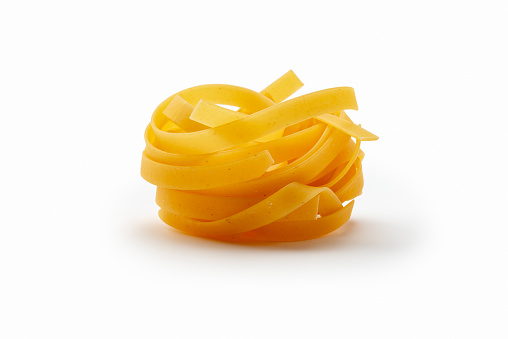 One Tagliatelle isolated on a white background. Studio shot. Side  view.