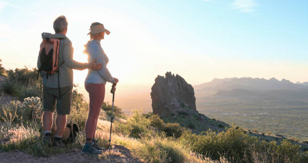 istock Hikers watch sunset over desert 2086389695