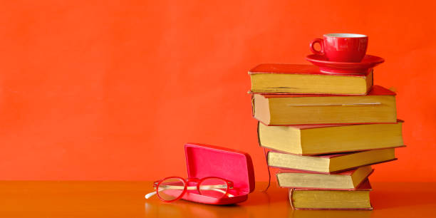 Stack of books with cup of espresso coffee and spectacles, reading, learning, knowledge is power,education or home office concept