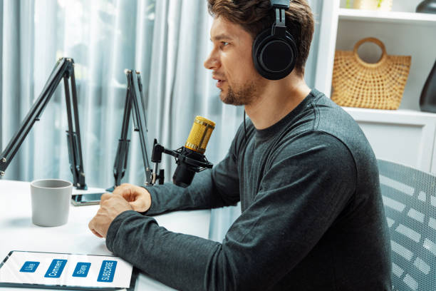 istock Man broadcaster wearing headphones making advice for problem in live. Postulate. 2086401762