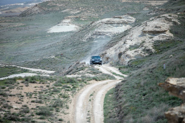 istock a car in a desert mountain 2086430696