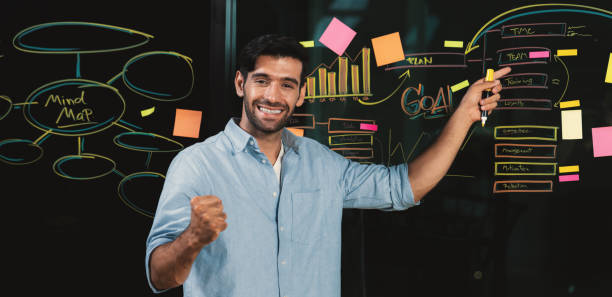 istock Businessman pointing at marketing statistic while looking at camera. Tracery. 2086468856