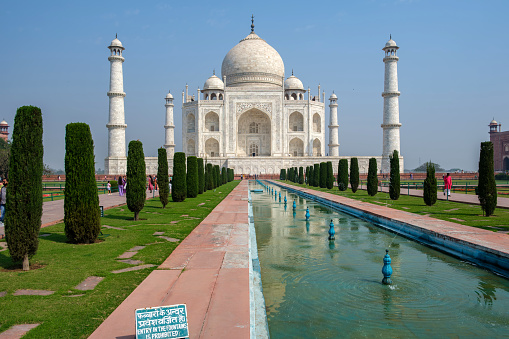 Beautiful view of the Taj Mahal, India one of the 7 wonder of the world, view from the gardens with perfect reflection on water surface