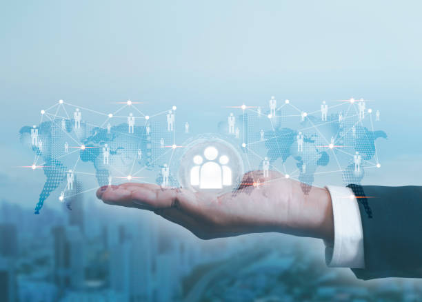 istock Businessman holds human resources icons in global network structure. customer network technology Customer relationship management concept global structure Customer service online marketing 2086469376