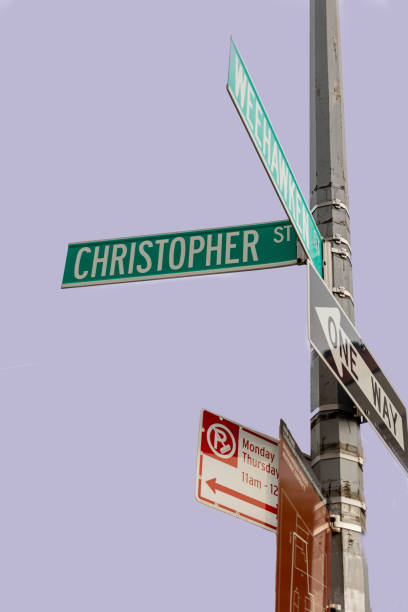 Manhattan, NY, USA–September 22th, 2023: Detached image of a lamppost with street name Christopher Street against a pink blue colored sky