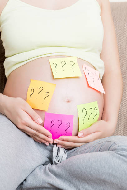 istock Pregnant woman belly with question mark. Pregnancy and thinking problem 2086498692