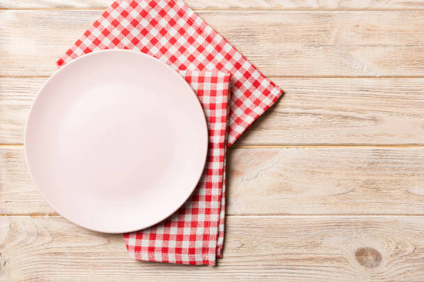 istock Top view on colored background empty round pink plate on tablecloth for food. Empty dish on napkin with space for your design 2086498716
