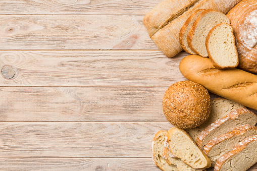 Homemade natural breads. Different kinds of fresh bread as background, top view with copy space.
