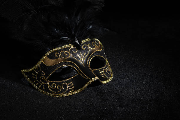 istock Carnival gold mask with feathers on black background. 2086499884