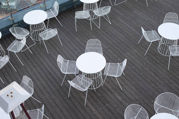 istock White circle table and chairs on wooden floor. view from above 2086518095