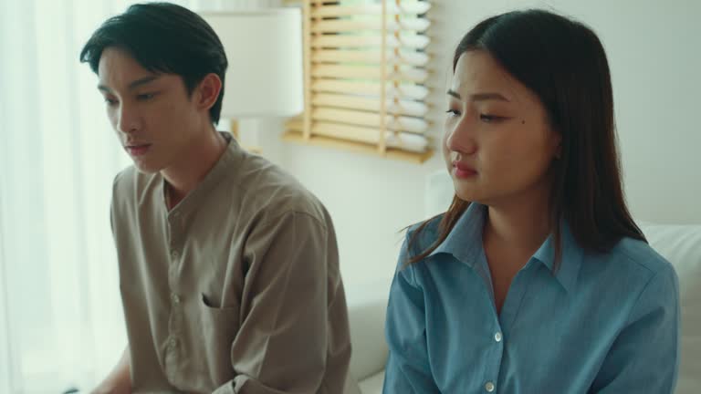 Close-up of Asian female psychotherapist advising couple after consult about mental health and relationship. Professional social worker assist married couples with empathy.