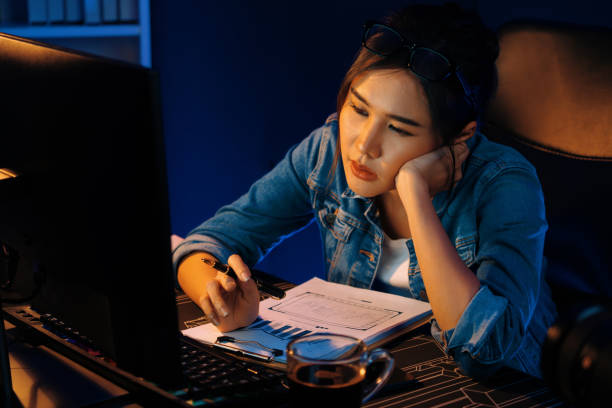 istock Exhausted young Asian creative feeling sleepy, looking on pc. Stratagem. 2086531624
