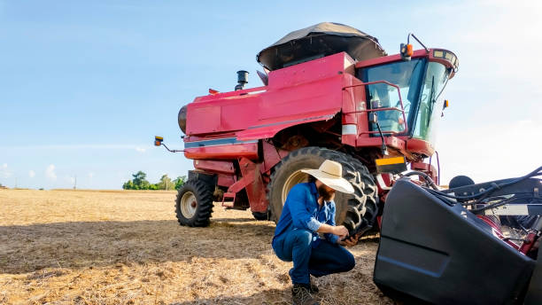 istock Man and a combine harvester. 2086535314