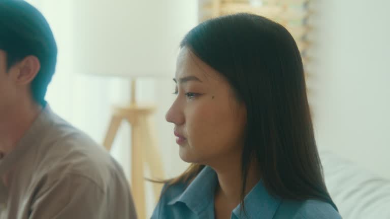 Close-up of Asian female psychotherapist advising couple after consult about mental health and relationship. Professional social worker assist married couples with empathy.