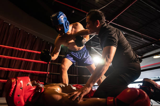 istock Boxing referee halting the fight to check KO competitor. Impetus 2086631372
