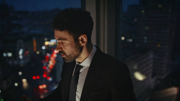 istock Desperate manager standing office window feeling stress after phone call closeup 2086654154