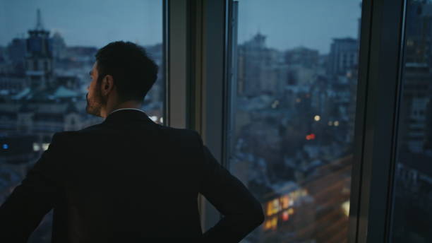 istock Pensive manager looking night city view in office window closeup. Serious worker 2086655196