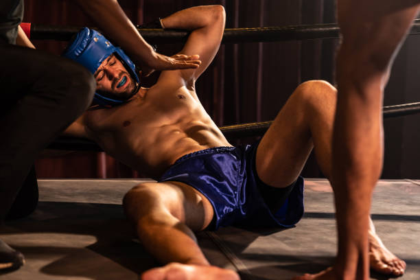 istock Boxing referee intervene, halting the fight to check fallen competitor. Impetus 2086659832
