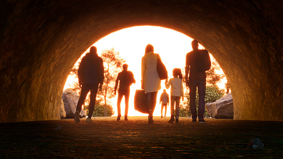 Refugees and immigrants looking for a new hope in life. Silhouette. Column of migrants passing through a tunnel. Abandon your lands for a better future. 3d rendering