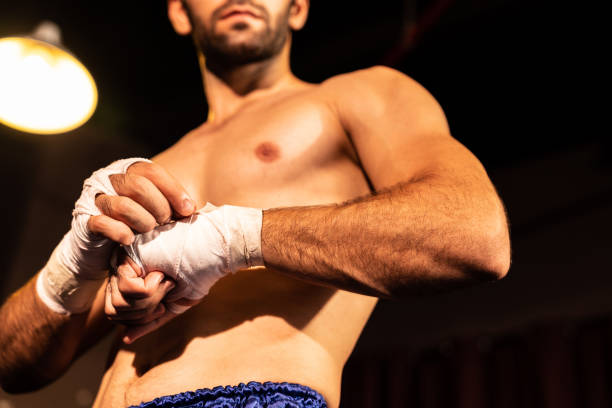 istock Caucasian boxer portrait wrapping his hand. Impetus 2086674507