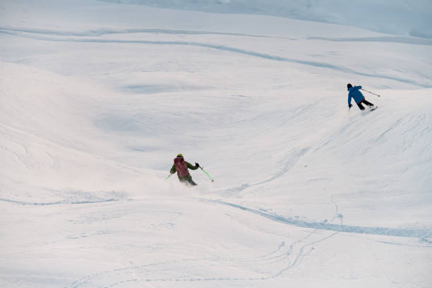 istock Two skiers go down the snowy slope together 2086683001