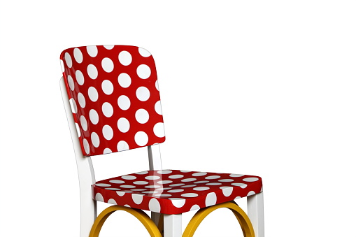 red wooden chair painted with white balls and yellow details