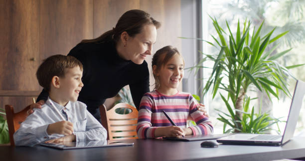 istock Mother, son and daughter drawing pictures using laptop computer, digitized pen and graphics tablet 2086702002
