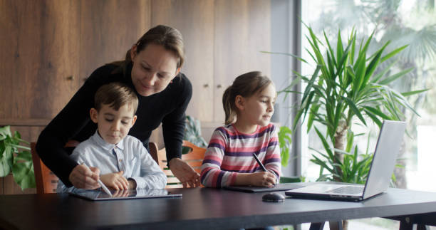 istock Mother, son and daughter drawing pictures using laptop computer, digitized pen and graphics tablet 2086709950
