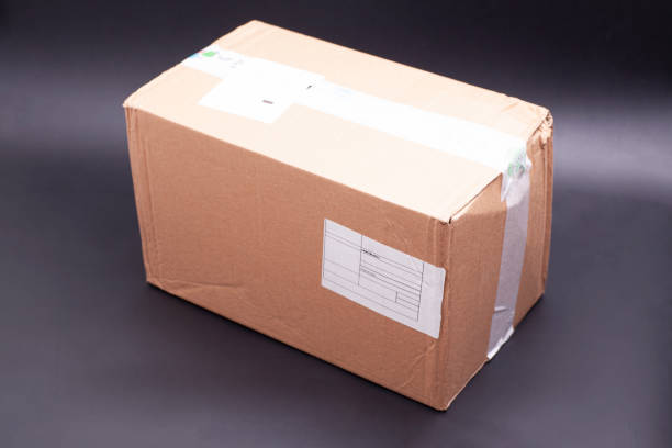 istock Cardboard box with tape on black background 2086715746