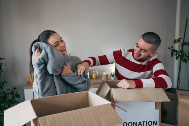 istock Young married couple packing their clothes for charitable organisation 2086726263